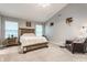 Spacious bedroom with a wood-framed bed, chair, and lots of natural light from the windows at 11919 Gatwick View Dr, Fishers, IN 46037