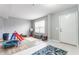 Bonus room with play area featuring wood floors, ample natural light, and neutral paint at 11919 Gatwick View Dr, Fishers, IN 46037