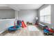 Bonus room with play area featuring wood floors, ample natural light, and neutral paint at 11919 Gatwick View Dr, Fishers, IN 46037