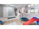 Bonus room with play area featuring wood floors, ample natural light, and neutral paint at 11919 Gatwick View Dr, Fishers, IN 46037