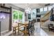 Bright dining area features tile flooring, slider to deck, view of fireplace and open access to living room at 11919 Gatwick View Dr, Fishers, IN 46037