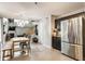 Open layout dining and kitchen with stairs, tile flooring, modern decor, and abundant natural light at 11919 Gatwick View Dr, Fishers, IN 46037