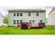 Exterior of home featuring a backyard deck accessible from sliding glass doors and a well-kept lawn at 11919 Gatwick View Dr, Fishers, IN 46037