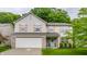 Two-story home with light siding, wooden shutters, brick accents, and a manicured front yard at 11919 Gatwick View Dr, Fishers, IN 46037