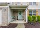 Charming front porch with a blue door, chairs, and decorative plants at 11919 Gatwick View Dr, Fishers, IN 46037