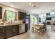 Modern kitchen with dark cabinets, stainless steel appliances and an adjacent dining area with backyard access at 11919 Gatwick View Dr, Fishers, IN 46037