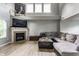 Comfortable living room with a fireplace and large sectional sofa, perfect for relaxation and entertaining at 11919 Gatwick View Dr, Fishers, IN 46037