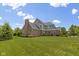 Large backyard featuring mature trees and well-maintained lawn at 11984 Talnuck Cir, Fishers, IN 46037