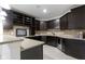 Basement bar area featuring dark cabinets, granite countertops, and ample storage space provides a space to entertain at 11984 Talnuck Cir, Fishers, IN 46037