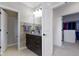 Well-appointed bathroom with a granite countertop vanity, modern lighting, and a convenient walk-in closet at 11984 Talnuck Cir, Fishers, IN 46037