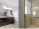 Elegant bathroom showcasing a glass-enclosed shower, soaking tub, and stylish vanity with granite countertops at 11984 Talnuck Cir, Fishers, IN 46037