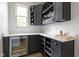 Stylish butler pantry with wine fridge, wine rack, and plenty of counter space for entertaining at 11984 Talnuck Cir, Fishers, IN 46037