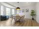 Bright dining room with large windows, modern light fixture, and a seating area at 11984 Talnuck Cir, Fishers, IN 46037