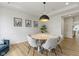 Cozy dining room featuring a modern light fixture and decorative wall paneling at 11984 Talnuck Cir, Fishers, IN 46037
