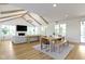 Open concept floor plan with dining area adjacent to living room with vaulted ceilings and wood beams at 11984 Talnuck Cir, Fishers, IN 46037
