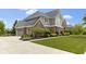 Charming two-story home with a three-car garage, brick detailing, manicured shrubbery, and green lawn at 11984 Talnuck Cir, Fishers, IN 46037