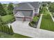 Immaculate two-story home featuring a three-car garage, brick accents, and beautifully landscaped grounds at 11984 Talnuck Cir, Fishers, IN 46037