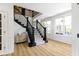 Inviting foyer with a striking staircase, hardwood floors, and natural light streaming through large windows at 11984 Talnuck Cir, Fishers, IN 46037