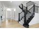 Elegant foyer showcasing a grand staircase with decorative iron railings and an arched doorway at 11984 Talnuck Cir, Fishers, IN 46037