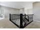 Spacious hallway with a staircase featuring dark railing and neutral colored carpet at 11984 Talnuck Cir, Fishers, IN 46037