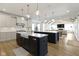 Spacious kitchen featuring double islands, white cabinets, and hardwood floors; open to the living area at 11984 Talnuck Cir, Fishers, IN 46037