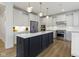 Stunning kitchen with a large island, white cabinets, stainless steel appliances, and hardwood floors at 11984 Talnuck Cir, Fishers, IN 46037