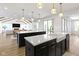 Gourmet kitchen featuring double islands, hardwood floors, and stylish pendant lighting at 11984 Talnuck Cir, Fishers, IN 46037