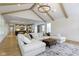 Spacious living room featuring a large sectional sofa, coffered ceiling, and open layout to the kitchen at 11984 Talnuck Cir, Fishers, IN 46037