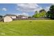 Expansive backyard with a wooden fence and a fire pit area at 1222 Grand Canyon Ct, Franklin, IN 46131