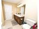 Brightly-lit bathroom with double sinks, wood cabinets, and neutral colored walls at 1222 Grand Canyon Ct, Franklin, IN 46131