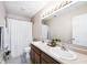 Bathroom with double sinks, wood cabinets, and a large mirror at 1222 Grand Canyon Ct, Franklin, IN 46131