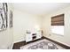 Light-filled bedroom showcases a patterned rug, a white cabinet, and a window with neutral blinds at 1222 Grand Canyon Ct, Franklin, IN 46131