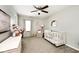 Bedroom with crib, dresser, ceiling fan, and a neutral color palette at 1222 Grand Canyon Ct, Franklin, IN 46131