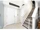 Bright entryway featuring tiled floor, stairway with safety gate and a white front door at 1222 Grand Canyon Ct, Franklin, IN 46131