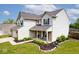 Side view of a two-story home with white siding and a manicured lawn at 1222 Grand Canyon Ct, Franklin, IN 46131