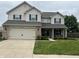 Charming two-story home featuring a well-manicured lawn, attached two-car garage, and a welcoming front entrance at 1222 Grand Canyon Ct, Franklin, IN 46131