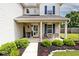 Inviting front porch with brick accents, plants, and seating area at 1222 Grand Canyon Ct, Franklin, IN 46131