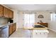 Bright kitchen features an island, stainless steel appliances, wood cabinets and sliding door to the backyard at 1222 Grand Canyon Ct, Franklin, IN 46131