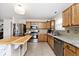 Kitchen featuring tile floors, wooden cabinetry, and stainless steel appliances at 1222 Grand Canyon Ct, Franklin, IN 46131