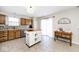 Bright kitchen features an island, stainless steel appliances, wood cabinets and sliding door to the backyard at 1222 Grand Canyon Ct, Franklin, IN 46131