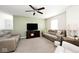 Spacious living room with plush sofas, a ceiling fan and neutral carpet for comfortable living at 1222 Grand Canyon Ct, Franklin, IN 46131