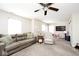 Comfortable living room features plush seating, a ceiling fan, and neutral carpet for relaxation at 1222 Grand Canyon Ct, Franklin, IN 46131