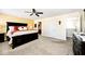 Spacious main bedroom featuring a ceiling fan, neutral carpet, and large dark wood furnishings at 1222 Grand Canyon Ct, Franklin, IN 46131
