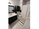Charming bathroom with black vanity and black framed mirror, and patterned tile floors at 12853 Tradd St # 2B, Carmel, IN 46032