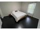 Simple bedroom design with large window allowing ample natural light into the space at 12853 Tradd St # 2B, Carmel, IN 46032