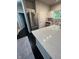 Bright kitchen with marble countertops, stainless steel appliances, and dark hardwood flooring at 12853 Tradd St # 2B, Carmel, IN 46032