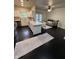 Bright living room featuring dark wood floors, open layout to kitchen, and doors to the outside at 12853 Tradd St # 2B, Carmel, IN 46032