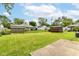 Lush backyard with green grass, storage sheds, and a fenced-in perimeter at 1308 N Main St, Lapel, IN 46051