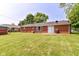 Expansive backyard showcasing a well-maintained lawn and the brick exterior of the house at 1308 N Main St, Lapel, IN 46051