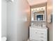 Well-lit bathroom featuring a vanity with a marble countertop and a mirrored medicine cabinet at 1308 N Main St, Lapel, IN 46051